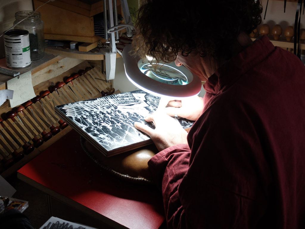 Neil Bousfield working on his engravings for the Folio limited edition of Wilfred Owen