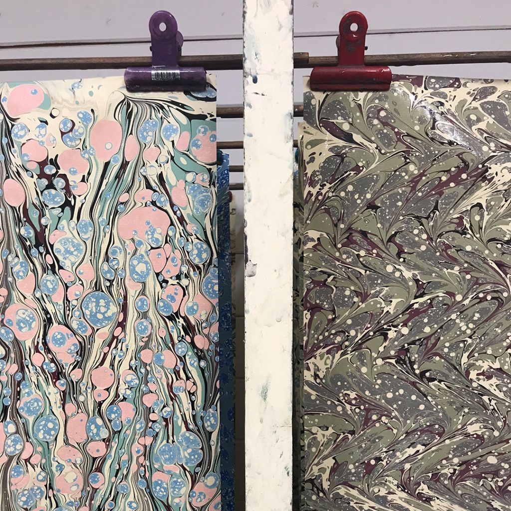 Marbled paper drying, created by artist Jemma Lewis