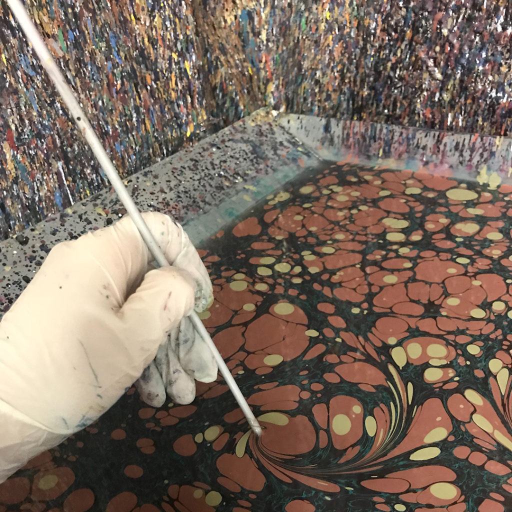 Marbled paper being created by Jemma Lewis