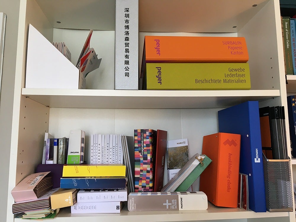 Catalogues full of different paper, cloth and material samples for book design and production